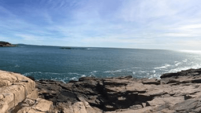 a rocky beach next to the ocean
