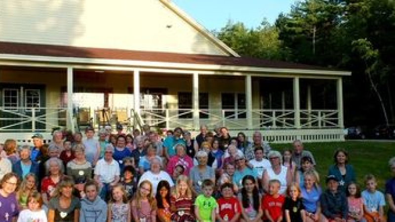 a group of people standing in front of a crowd posing for the camera