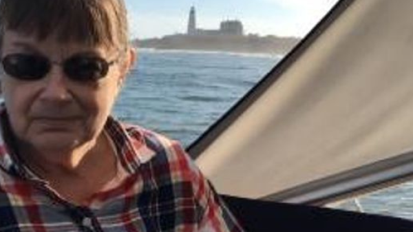 a man wearing glasses and smiling at the camera