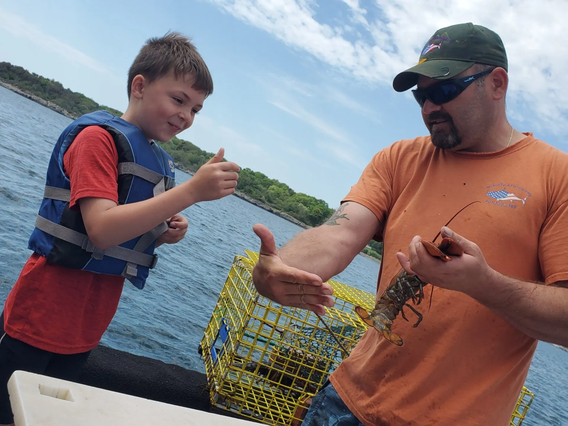 a man holding a baby in a body of water