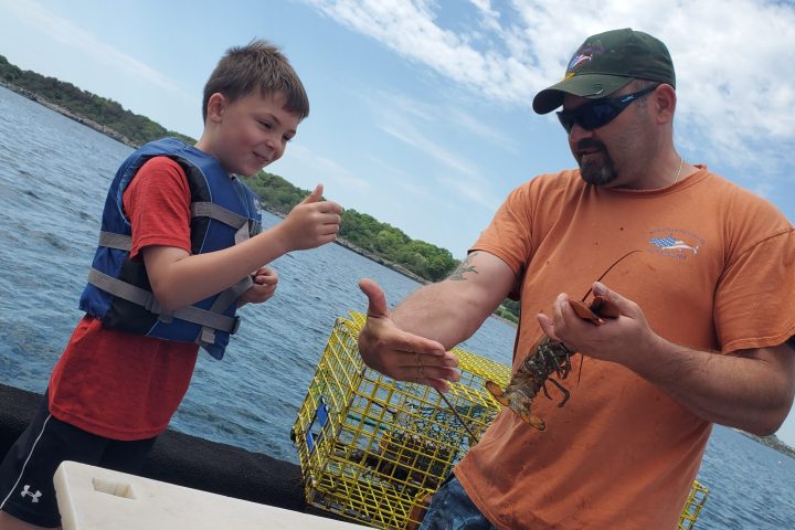a man holding a baby in a body of water