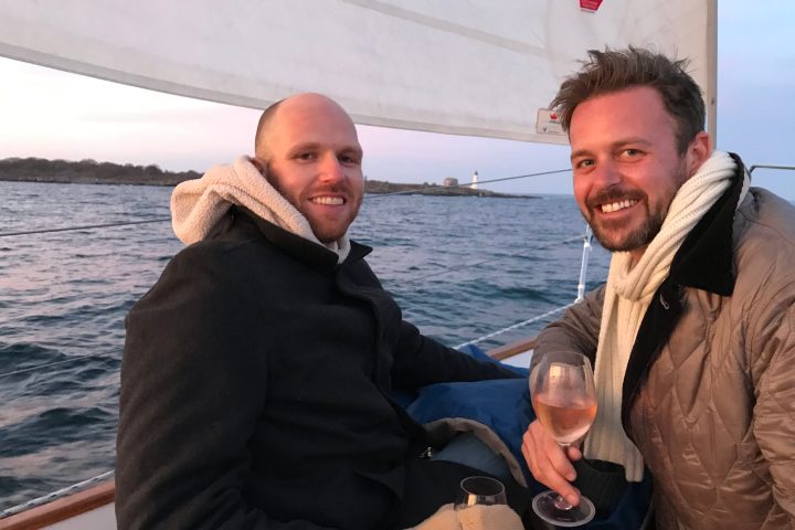 a man standing next to a body of water