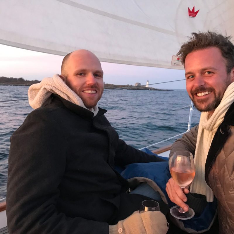 a man standing next to a body of water