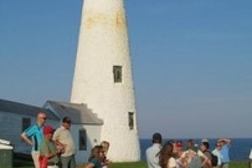 a group of people standing in front of a tower