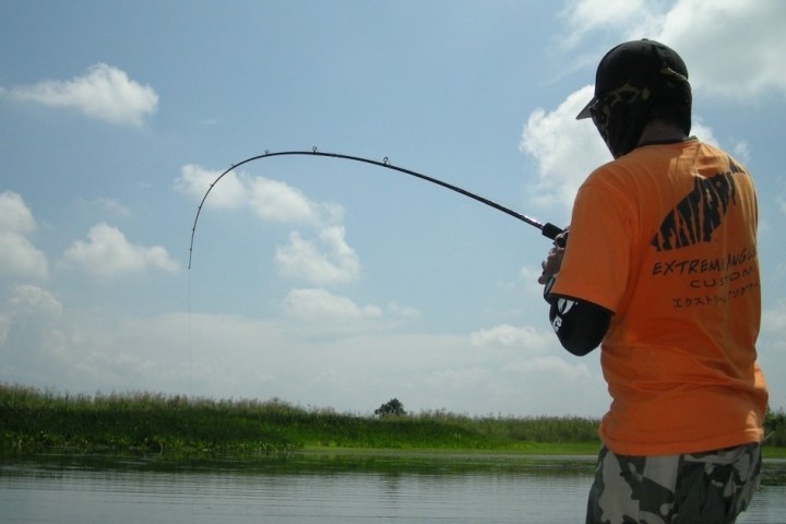 a man standing next to a body of water