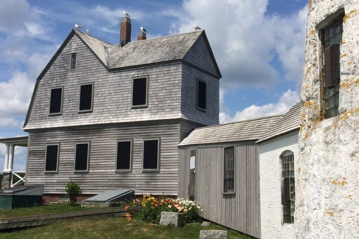 a large brick building with grass in front of a house