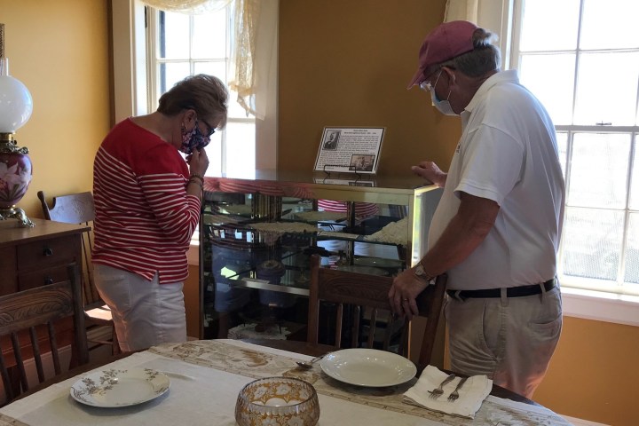 a man sitting at a table with a cake