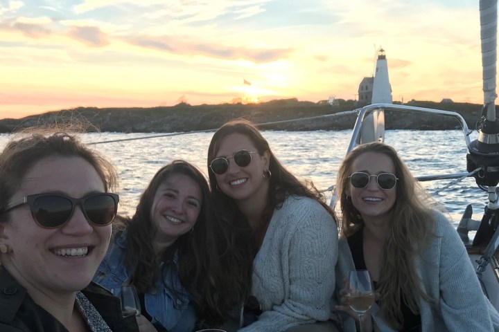 a couple of people posing for a picture next to a body of water