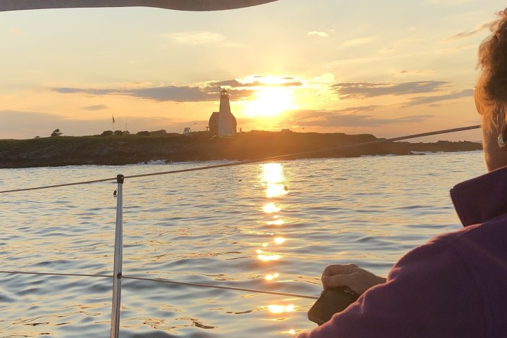 a person standing next to a body of water