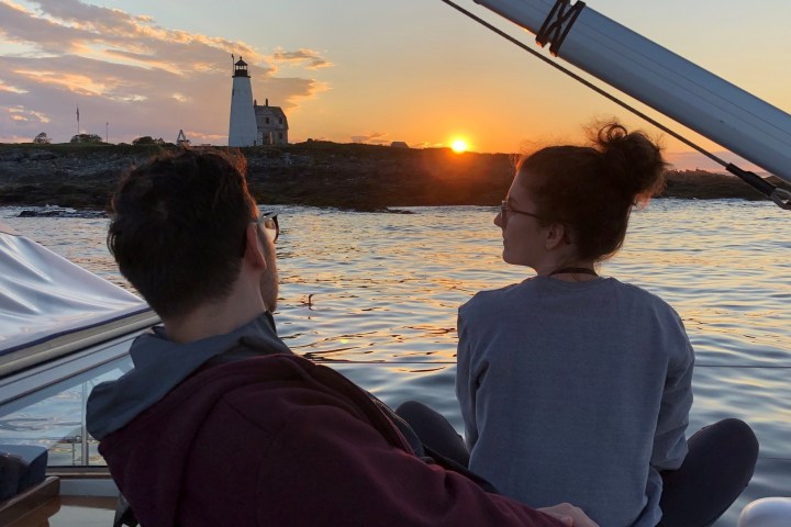 a man standing in front of a body of water