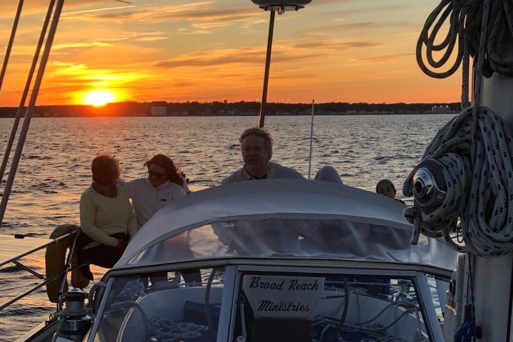 a person sitting in a boat on a body of water