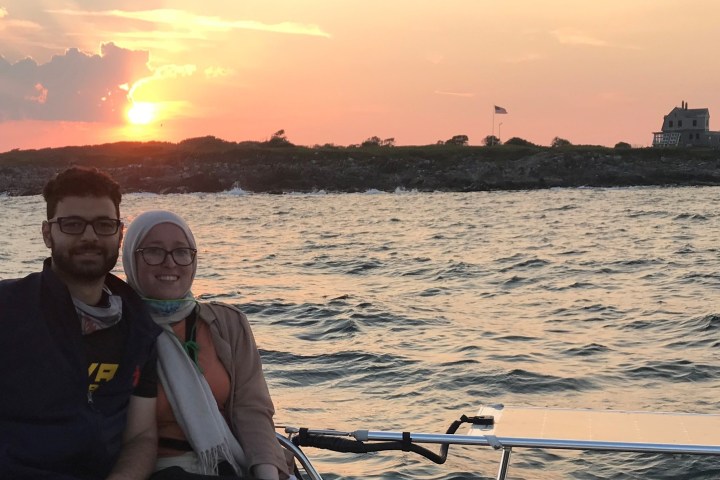 a man standing next to a body of water