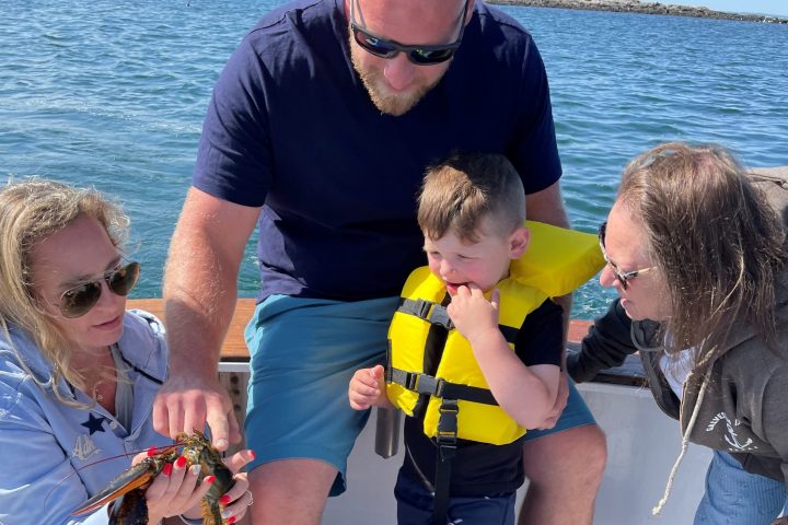 a couple of people standing next to a body of water