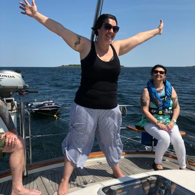 a person sitting on a dock next to a body of water