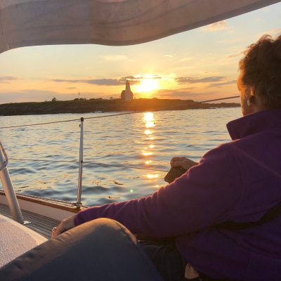 a person sitting in a boat on a body of water