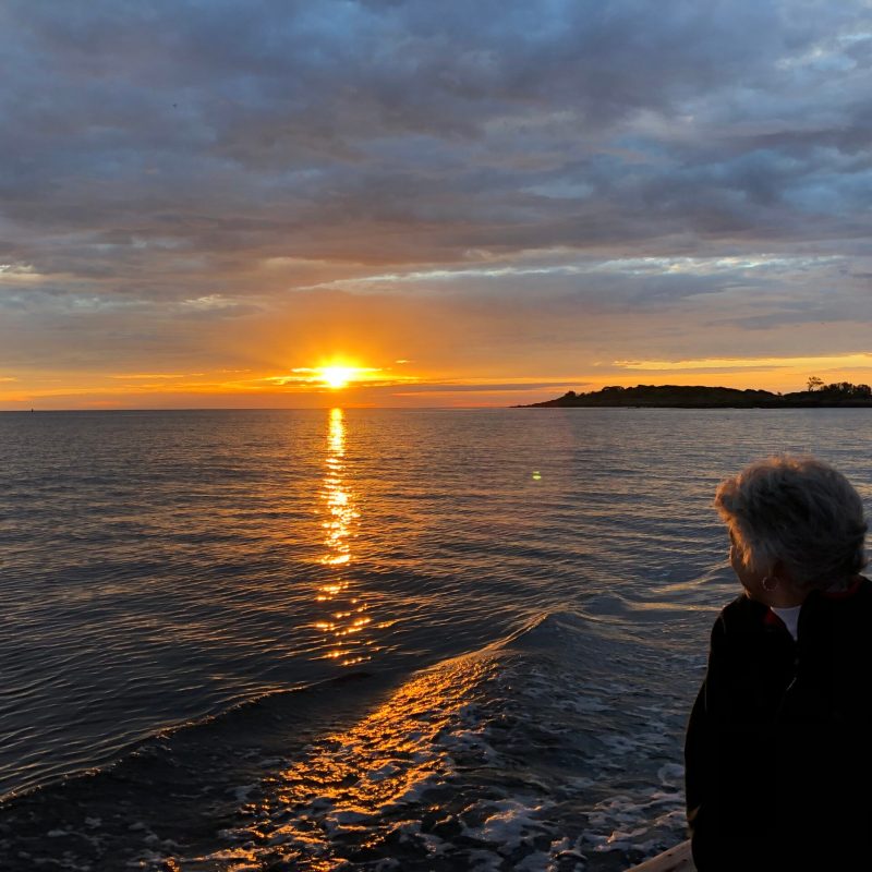 a man standing next to a body of water