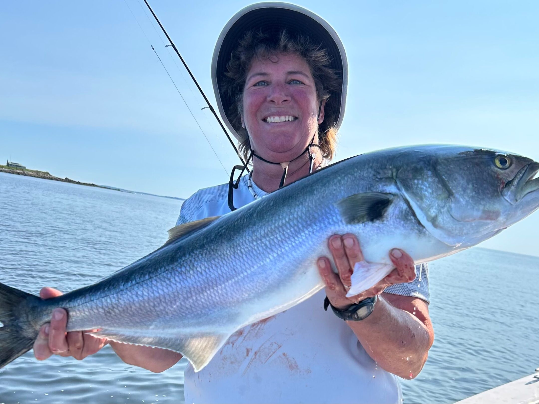 a man holding a fish swimming under water