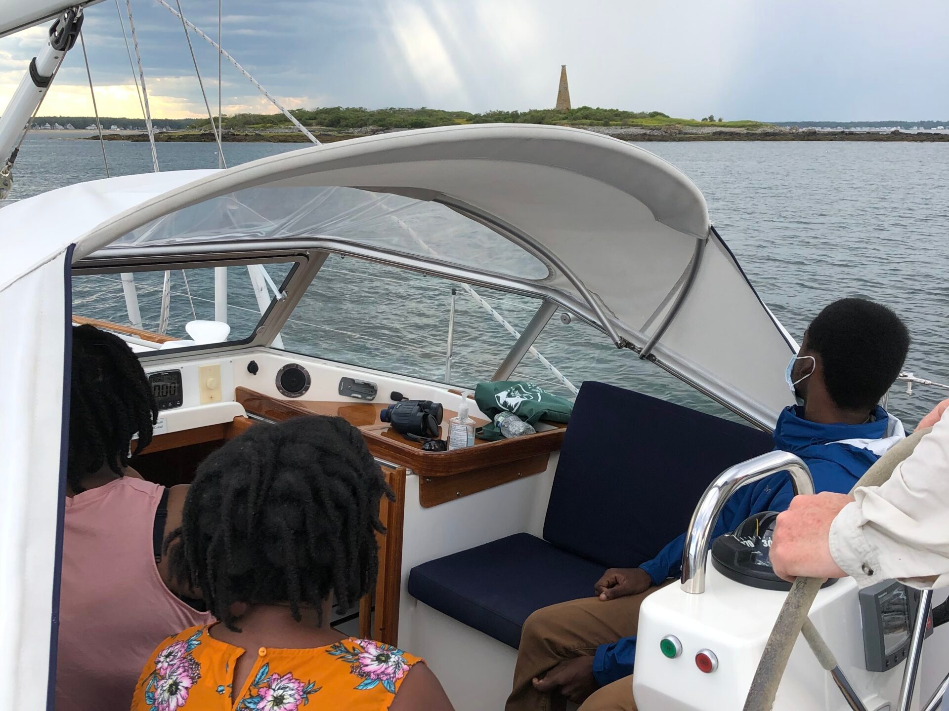 a boy sitting on a boat in the water
