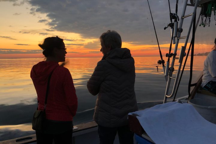 a man standing next to a body of water