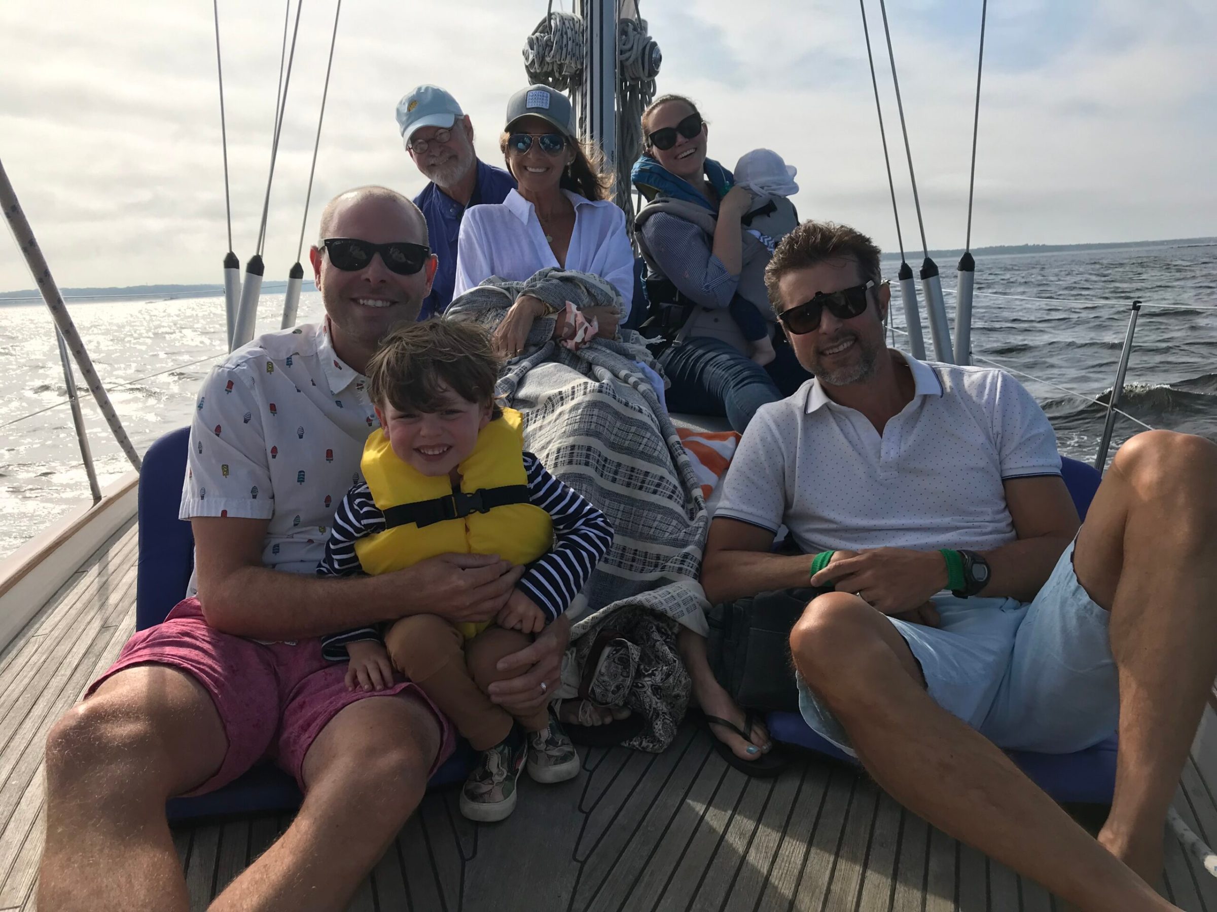 a group of people sitting in a boat on a body of water
