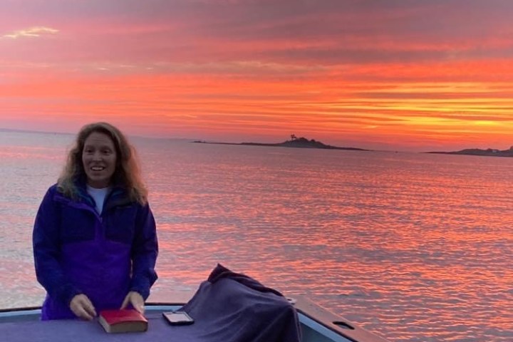 a person sitting next to a body of water
