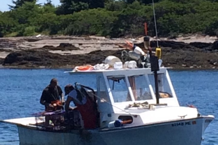 a group of people in a small boat in a body of water
