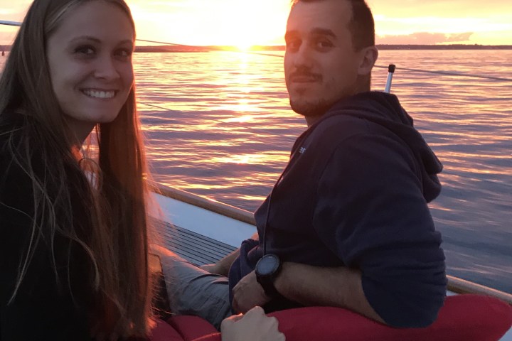 a woman standing next to a body of water