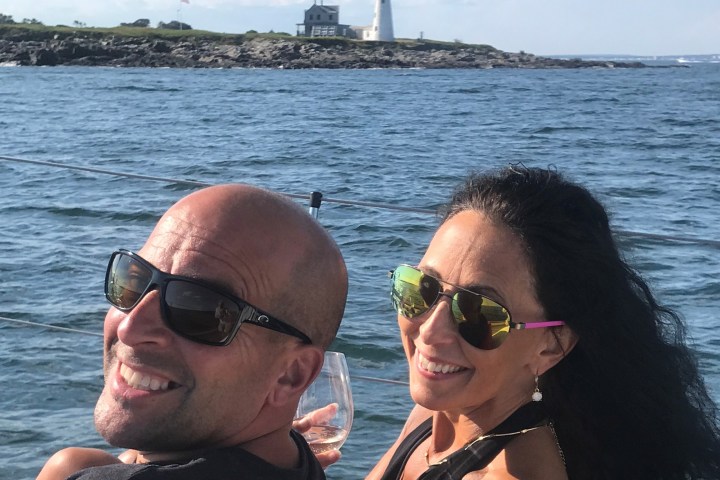 a person sitting on a dock next to a body of water