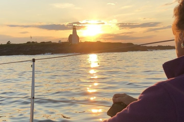 a man standing next to a body of water